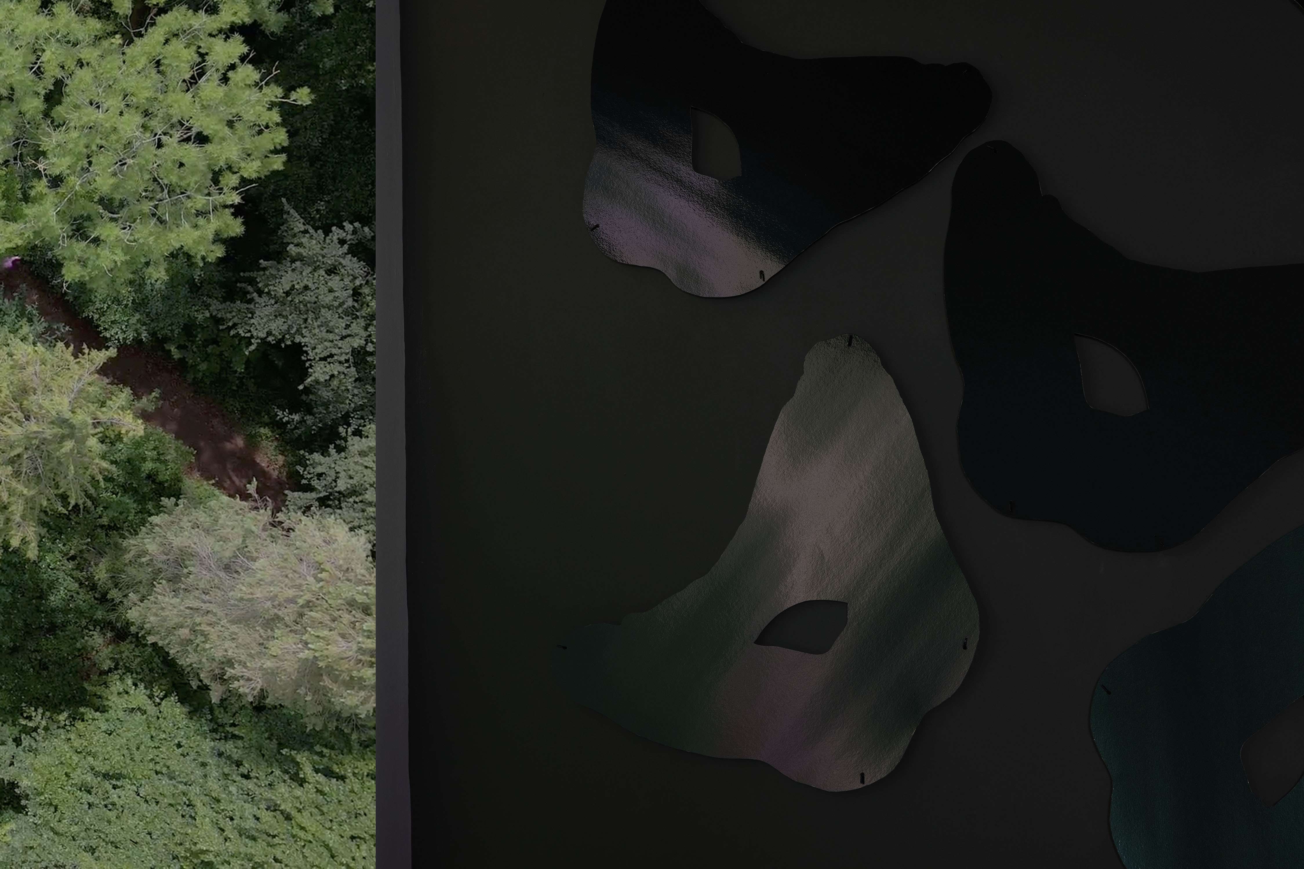 A dark green wall with several reflective seat shapes reflects the film being projected on the wall next to them.